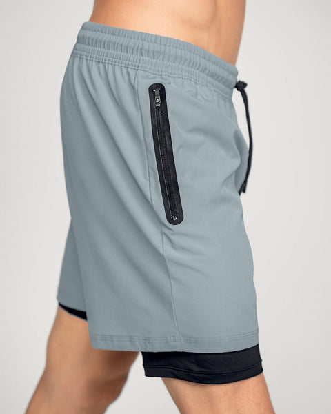 Pantaloneta deportiva con bolsillo lateral con bóxer interno#color_731-gris