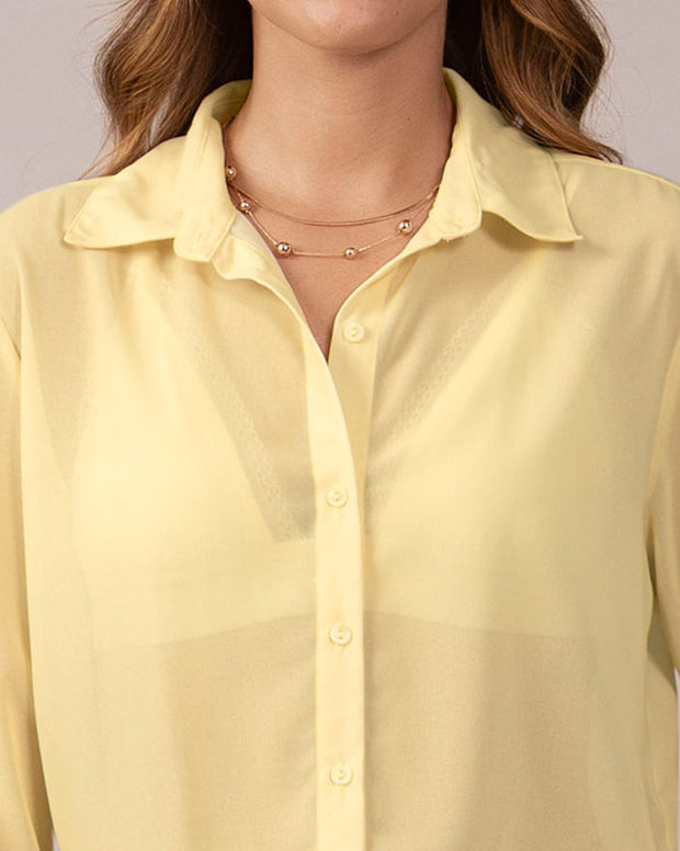 Blusa manga larga elaborada en tela con transparencia